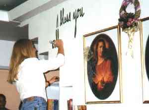 Vassula is photographed while writing Jesus' message onto the wall